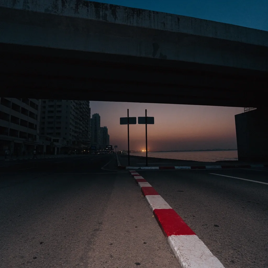 A Dubai street at dusk with new blank signposts and long shadows across the carriageway