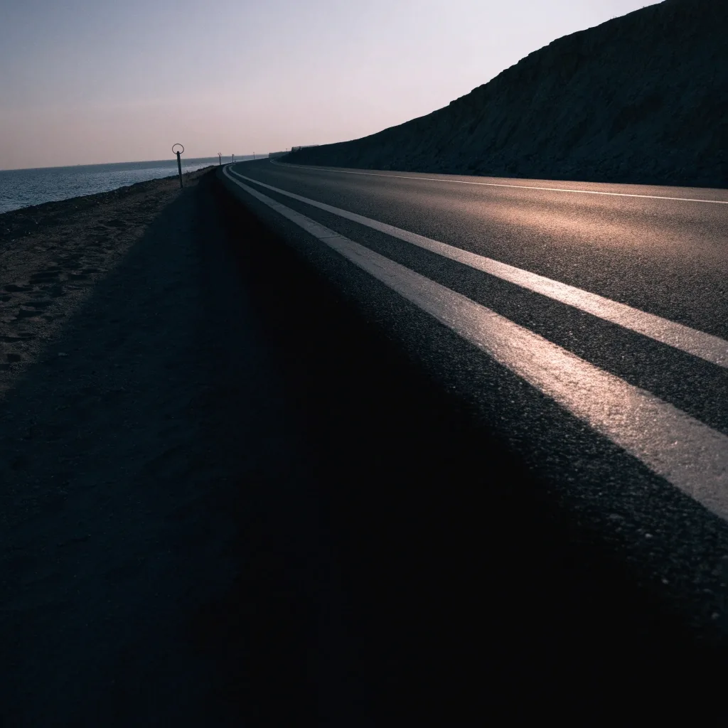 A Gulf road at first light seen from a low vantage near the water