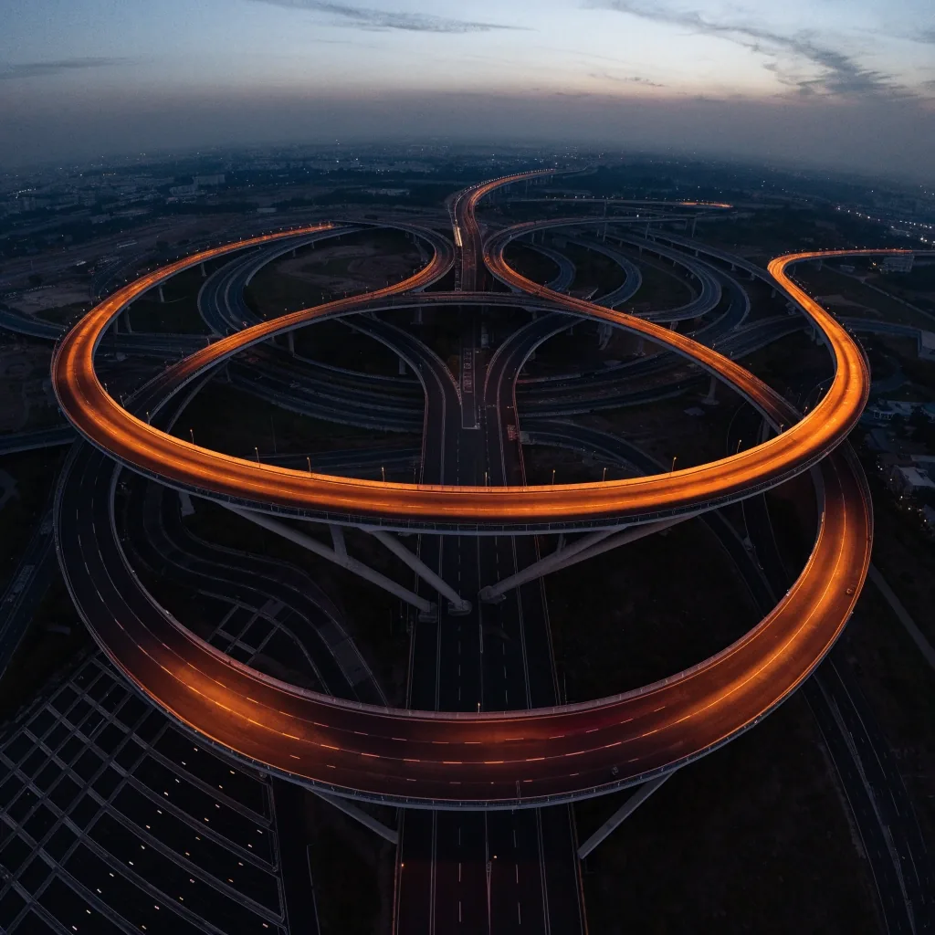 Aerial view of a Dubai road interchange with layered ramps at dusk